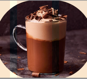 Hot chocolate with whipped cream and chocolate syrup in a ceramic mug, served with marshmallows.