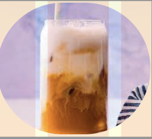 Iced latte in a tall glass with ice, milk, and espresso, served with a straw.