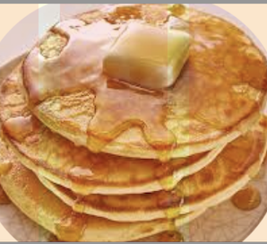 A stack of golden pancakes drizzled with maple syrup and topped with a melting pat of butter, evoking a comforting family breakfast moment.