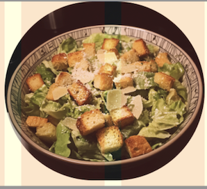 A bowl of classic Caesar salad with crisp romaine lettuce, crunchy croutons, Parmesan cheese, and a creamy dressing for a timeless meal.