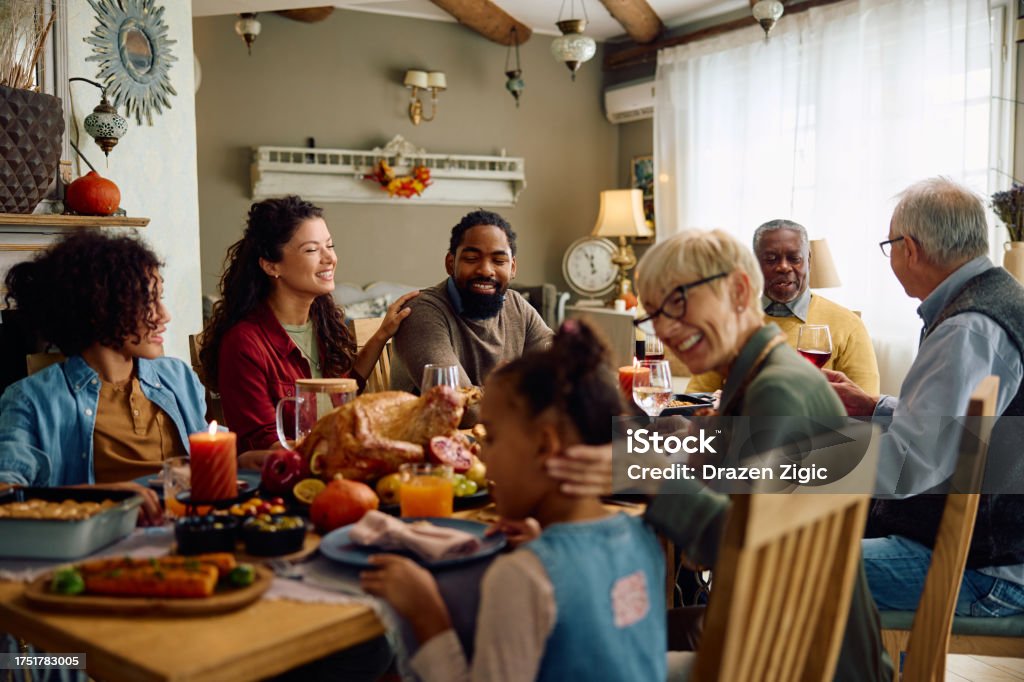 A cheerful, multigenerational family enjoying a festive meal at Velvet Roast Café.